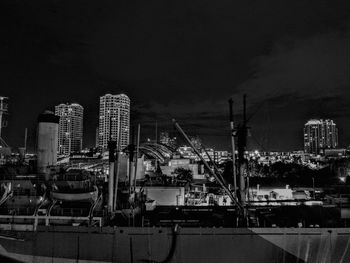 Illuminated cityscape against clear sky at night