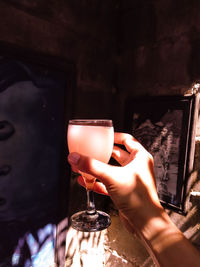 Midsection of person holding wineglass