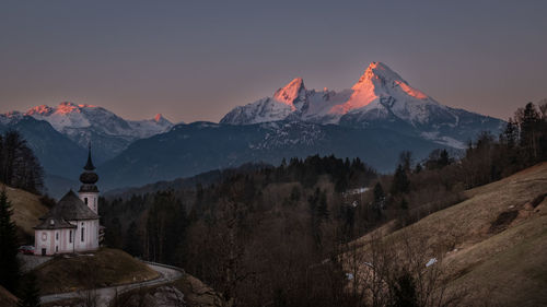 Scenic view of snowcapped mountains against sky during sunset