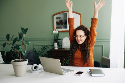 Young woman using laptop at home