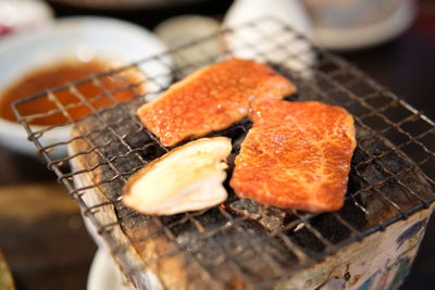 High angle view of meat on barbecue grill