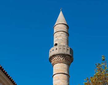 Low angle view of historic building against clear blue sky