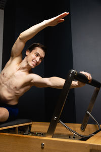 Low angle view of young woman exercising in gym