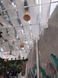 Low angle view of lanterns hanging by building