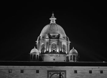 Low angle view of illuminated cathedral against sky at night