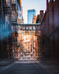 Street amidst buildings in city against sky