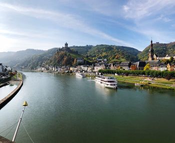 Scenic view of river and mountains against sky