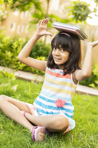 Portrait of young woman sitting on grass