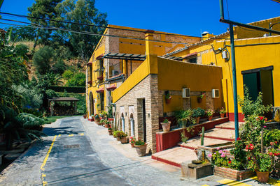 Yellow and buildings against clear sky