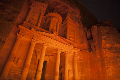 Low angle view of illuminated building at night
