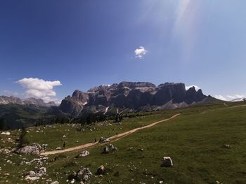 Scenic view of land and mountains against sky