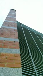 Low angle view of tall building against clear sky