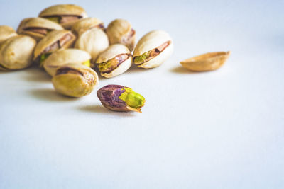 Close up group of dry, fresh and large raw pistachio nuts in shell