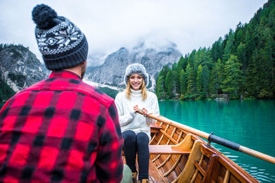 Woman wearing hat against mountains during winter