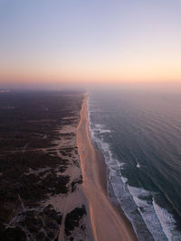 Scenic view of sea against clear sky during sunset