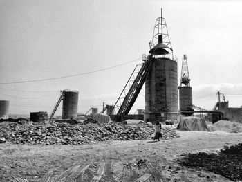 Communications tower on land against sky