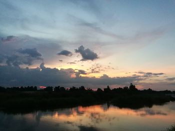 Scenic view of lake against sky during sunset