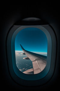 View of blue sky seen through airplane window