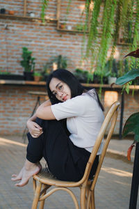 Young woman sitting on chair