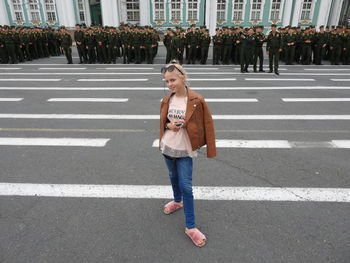 Portrait of smiling girl standing on city street