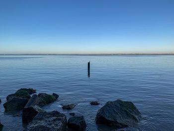 Scenic view of sea against clear blue sky