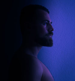 Portrait of young man against blue background