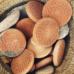 High angle view of earthenware lids in wicker basket
