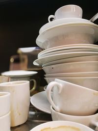 Close-up of coffee cups and bowls on table
