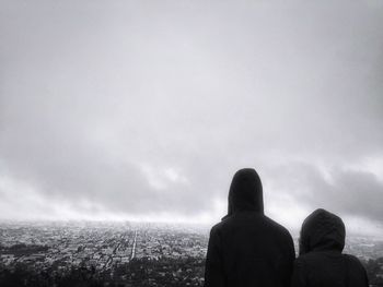 Silhouette of woman against cloudy sky