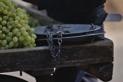Close-up of grapes hanging on table
