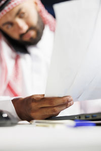 Midsection of man working at table