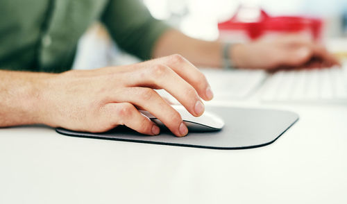 Midsection of woman using laptop on table