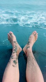 Low section of man resting at beach