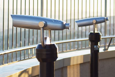Close-up of camera on railing