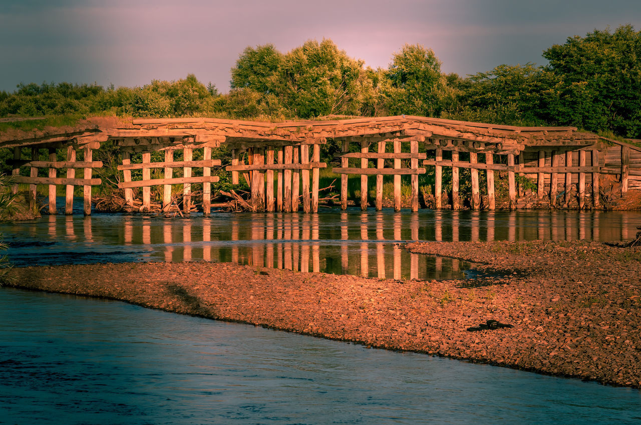 BRIDGE OVER RIVER AGAINST TREES