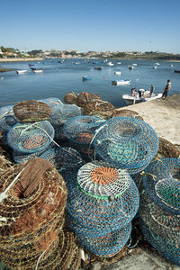 High angle view of crab pots on pier by river against clear sky