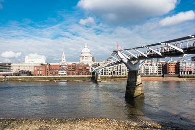 Bridge over river with buildings in background