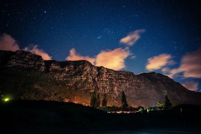 Scenic view of mountains against sky at night