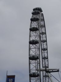 Low angle view of ferris wheel against sky