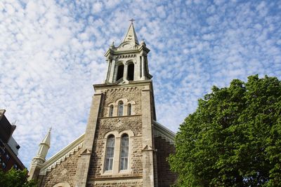 Low angle view of building and trees against sky