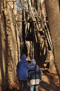 Rear view of people in forest