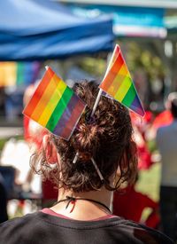 Rear view of person with rainbow flags in hair