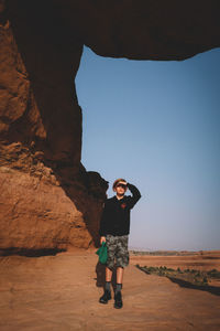 Full length of man standing on rock