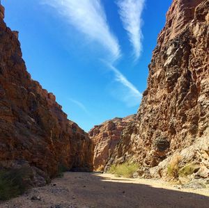 Road amidst rocks against sky