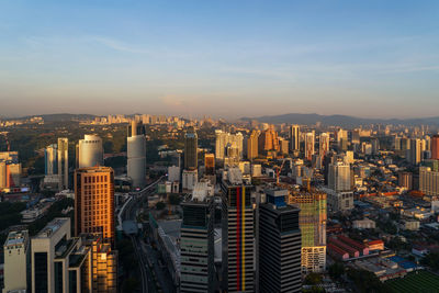 Aerial view of modern buildings in city against sky