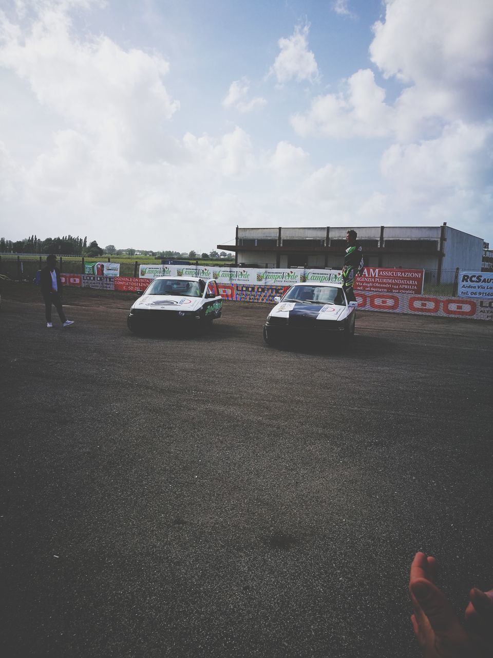 VEHICLES ON ROAD AGAINST SKY