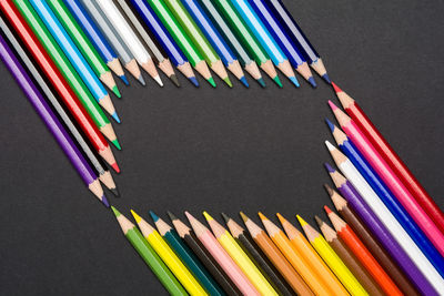 High angle view of multi colored pencils against black background