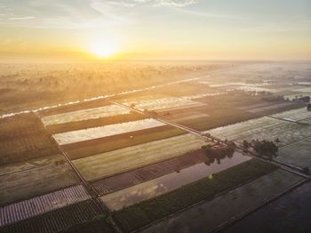 High angle view of field against sky during sunset