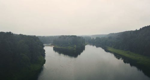 Scenic view of river amidst trees against clear sky