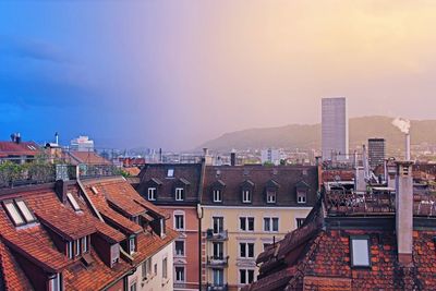 Houses in city against sky